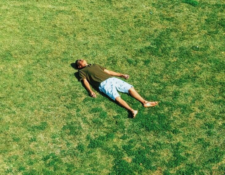 man lying on grass