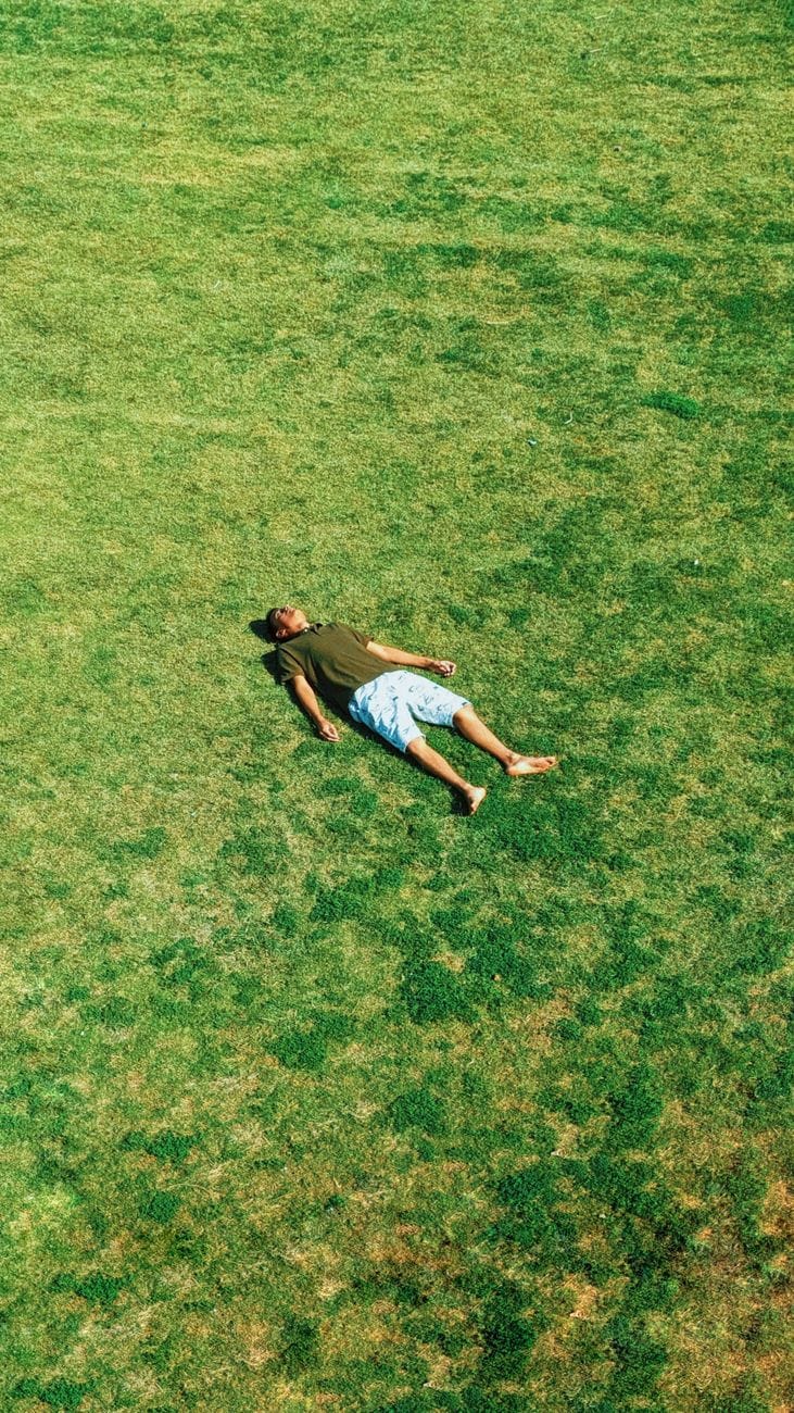 man lying on grass